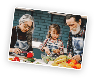 elderly couple with kid preparing meal